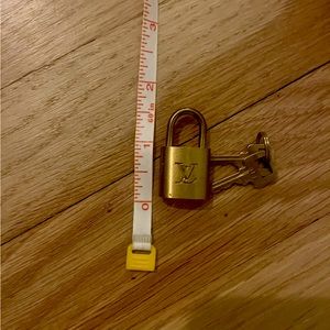 Authentic Louis Vuitton brass lock with keys.